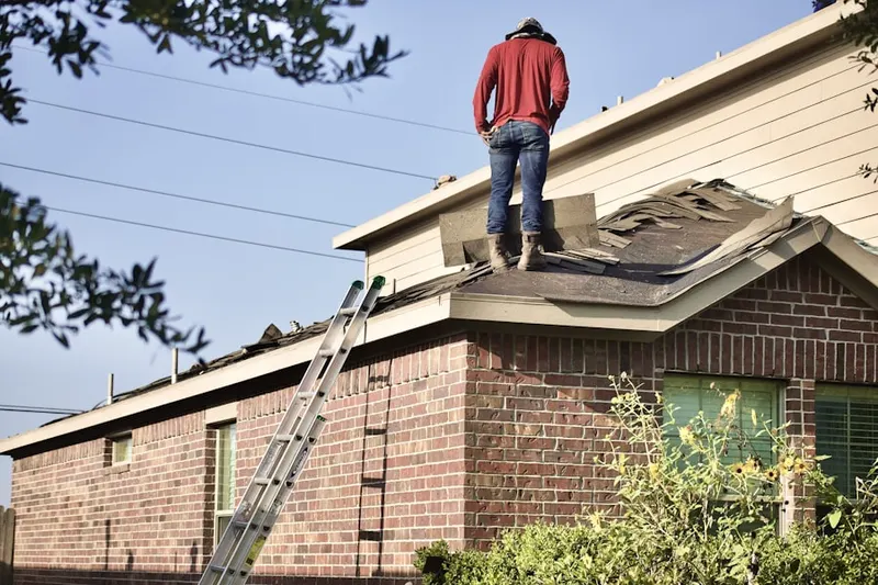 Professional roofer working on a residential roof in Wells Corner